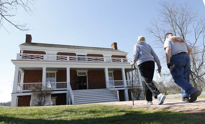 Visitors walk to the McLean house at the Appomattox Court House National Historical Park in Appomattox, Va., Wednesday, April 1, 2015. Confederate General Robert E. Lee surrendered his approximately 28,000 troops to Union General Ulysses S. Grant in the front parlor of Wilmer McLeanís home in Appomattox Court House, Virginia, effectively ending the American Civil War. (AP Photo/Steve Helber)