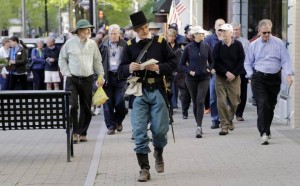 Ernest Dollar, director of the City of Raleigh Museum dressed as a Union Major, center, leads group up Fayetteville St. as he conducts a walking tour Monday, April 13, 2015 commemorating the 150th anniversary of the surrender of Raleigh to Union forces in 1865. Several other related events are scheduled for later in the day. CHRIS SEWARD CSEWARD@NEWSOBSERVER.COM