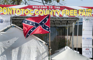 A Confederate battle flag flaps in the breeze Saturday morning at the Pontotoc County Free Fair on the grounds of the Agri-Plex. A vendor was selling the Confederate flag and other flags but took this one down after an Ada resident called the media to protest. Purchase this image at theadanews.smugmug.com. (Photo by Richard R. Barron)
