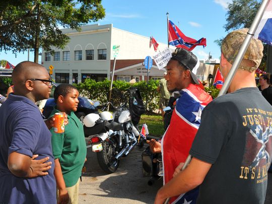 Augusta Williams III and Hilton Williams talk politics with Deyontae Richardson and Trevor Ward. (Photo: MALCOLM DENEMARK/FLORIDA TODAY)