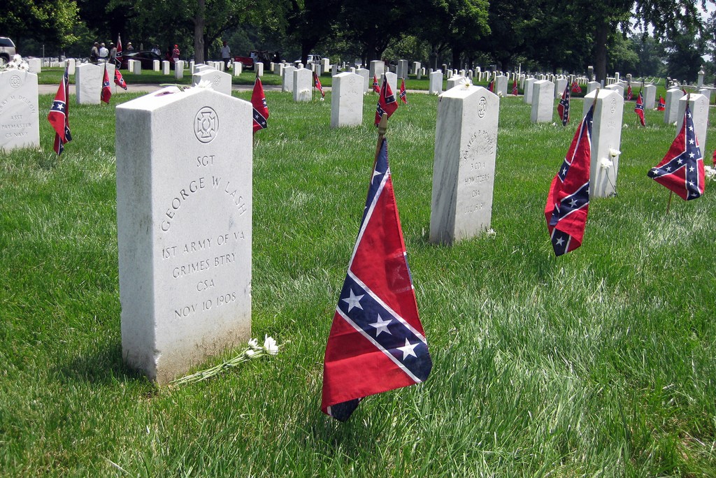 Confederate battle flags stand next to graves of soldiers in the Confederate section of Arlington National Cemetery. Today, a handful of Southern states mark Confederate Memorial Day as a state holiday. Photo by Wally Gobetz/Flickr.