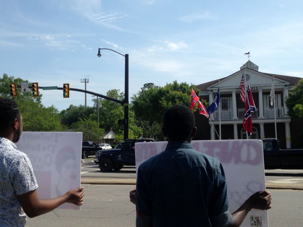 Protesters face off against flag supporters across the street.