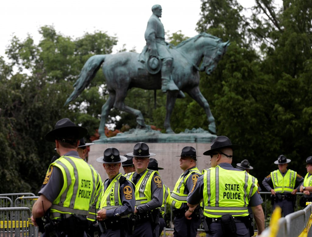 Virginia State Troopers stand under a statue of Robert E. Lee before the white supremacists rally in Charlottesville, Virginia, on August 12, 2017. Photo by REUTERS/Joshua Roberts