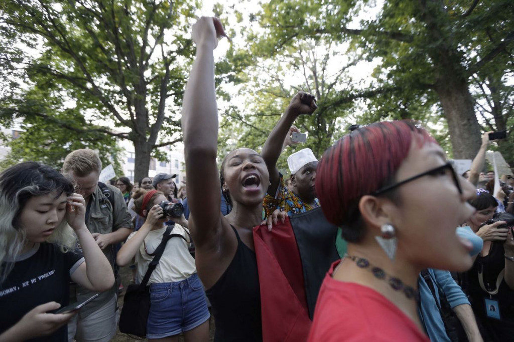 People protest at a Confederate monument at UNC-Chapel Hill on Aug. 22. The gathering focused on a statue known as “Silent Sam.” People chanted “tear it down” while uniformed officers watched from behind temporary metal barriers ringing the statue. Gerry Broome/The Associated Press 